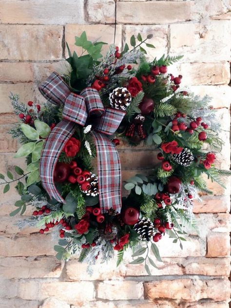 Traditional Pine Wreath with Red Berries throughout. A variety of winter greenery is nestled into our Canadian Pine base with Pinecones, red roses, and mini apples to enhance the overall appeal and warmth of our design. This design is created on an artificial Canadian Pine Base using high quality artificial greenery, florals and embellishments. Christmas Wreaths Indoor, Red Berry Wreath, Fall Decor Wreaths, Floral Door Wreaths, Decorated Wreaths, Winston Salem Nc, Christmas Door Wreaths, Pinecone Wreath, Christmas Wreaths For Front Door