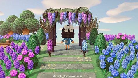 #animalcrossing #animalcrossingnewhorizons #acnh Acnh Pergola Design, Acnh Flower Island, Acnh Purple Flower Path, Acnh Gazebo Area, Pergola Animal Crossing, Acnh Flower Garden Designs, Animal Crossing Pergola Ideas, Acnh Rose Garden Ideas, Acnh Flower Fields