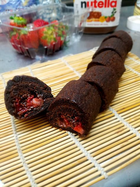 Because Nutella with strawberries are heavenly, we've put them into our brownie roll and called it "The Most Amazing Thing Ever Made", or something like that Chocolate Sushi, Sushi Dessert, Strawberry Brownie, Traditional Sushi, Sweet Sushi, Diwali 2024, Strawberry Brownies, Party Bites, Twins Birthday