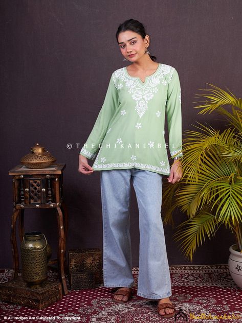 ▪ Pista Green Sangeet Modal Chikankari Short Kurta TheChikanLabel designer studio presents Pista Green Sangeet Modal Chikankari Short Kurta. Floral motifs with intricate embroidery delicately placed on handmade chikankari top. This perky hand embroidered Lucknowi chikankari top is a reminiscent of blooming springs and the serenity that surrounds it. Your skin will surely fall in love with soft fabric. This will keep you comfortable all day long and make yourself happier. ▪ Hand-Made, Not Machine Green Kurti Outfit With Jeans, Kurti For Jeans, Office Wear Kurta, Net Kurti, Shirt Kurti, Chikan Kurti, Kurti With Jeans, Indian Tops, Kurta Top