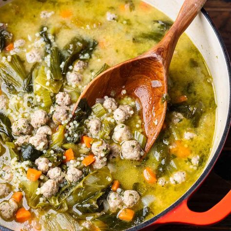 Italian Wedding Soup combines tiny meatballs made with beef and pork, acini di pepe pasta, fresh veggies, and greens simmered together in a tasty and nourishing broth. This may be a soup, but it's robust enough to be a complete meal! Tiny Meatballs, Traditional Italian Wedding, Italian Beef Stew, Pizza Sides, Sip And Feast, Italian Wedding Soup Recipe, Hearty Vegetable Soup, Italian Comfort Food, Homemade Chicken Stock