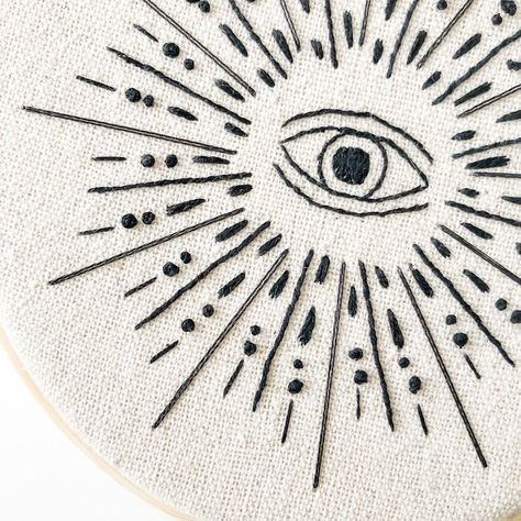 Stitch this modern and witchy Evil Eye embroidery pattern for your home. Known as a symbol of protection from evil in Eastern and Western cultures, The Evil Eye is also seen in the hamsa (the palm-shaped amulet with an eye in the centre of the palm); the hamsa is also called The Hand of Fatima, The Hand of Miriam, The Hand of Mary, and The Hand of Ishtar/Inanna. A beautiful and powerful symbol to stitch for yourself or others. #witchyembroidery #evileyeembroidery Hamsa Embroidery, Embroidery Patterns Witchy, Wicca Embroidery, Mystical Embroidery Pattern, Third Eye Embroidery, Occult Embroidery, Modern Evil Eye, Holiday Embroidery, Pretty Embroidery