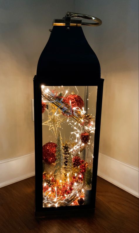 Found this metal and glass lantern 30”x10”x10” at Home Goods and sprayed it black. All decorations came from Hobby Lobby. Fun little project that will last for years! Black Lantern Decor, Lanterns For Christmas, Lantern With Fairy Lights, Christmas Lantern, Large Lanterns, Black Lantern, Iron Lanterns, Winter Craft, Metal Lanterns