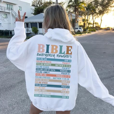 We produce the best quality designs for you like Bible Sayings Hoodie. Enjoy comfort and elegance.  Size: If you like a comfortable fit, you can increase your size selection by one size. If you're slim cut lover, please please make one size smaller. Wash Care Instruction: Please wash the product with cold water and turn inside out. Please do not dry at high temperature. Do not apply high pressure to the printing part while ironing on the product. If possible, iron the printing part on the baking Cute Christian Sweatshirts, Verses From Bible, Sweatshirt Sayings, Bible Sayings, Bible Emergency Numbers, Emergency Numbers, Christian Sweatshirts, Girly Christmas Gifts, Jesus Clothes