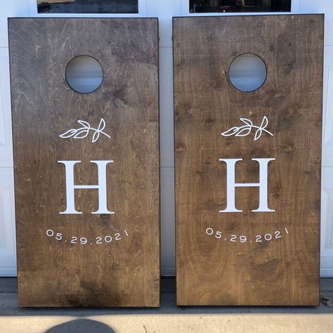 "Custom Wooden Cornhole Boards (bags sold separately - check our \"add on\" section) In the \"Notes to Seller\" section of please provide the following: 1. What you would like the cornhole boards to say 2. What font you would like us to use. Crafty Doods makes our boards out of premium birch plywood. Our boards are able to be stained or clear coated with polyurethane to protect the wood from minimal moisture exposure. Our boards are meant to be enjoyed outside, but should be stored in a dry/shad Wedding Bag Boards, Bag Boards Designs, Wedding Bean Bag Boards, Cornhole Guest Book Sign, Cornhole Wedding Boards, Cornhole Boards Designs Wedding, Cornhole Board Wedding, Corn Hole Boards Designs, Wedding Corn Hole