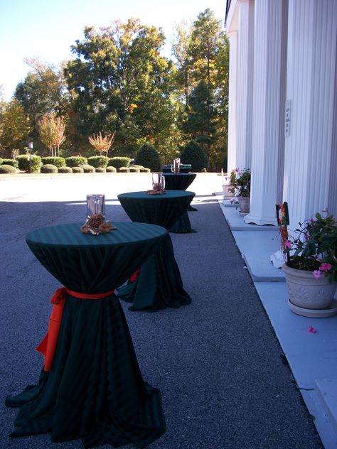 Here are our highboy cocktail tables with black linens and a red sash.  These are available on our website for rent. Black Linen Tablecloth, Football Lunch, Lunch Decor, Christmas Reception, Wedding Cocktail Tables, Cocktail Table Decor, White Pool, Table Rentals, Bourbon Tasting