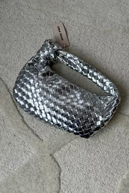 The most beautiful metallic bag to elevate any outfit. Bottega bag dupe | Designer dupes | Silver bag | Christmas Day outfit ideas | Trending bag | Metallic accessories | Statement | New Year’s Eve outfit #LTKparties #LTKitbag #LTKHoliday Silver Bottega Bag, Metallic Bag Outfit, Silver Bag Outfit, Bottega Bag Outfit, Silver Trousers, Bottega Bag, Pinterest Predicts, Silver Aesthetic, Metallic Accessories