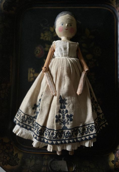 Item Details.  An antique Grodnertal Peg, Dutch, or Penny doll with a pleasant expression with naively painted hair around the face. She stands 11 1/4" tall with the expected jointed limbs and has a Folk Art hand carved look.   Her clothing is antique consists of a petticoat, and embroidered skirt. She is also wearing a shorter petticoat and  bloomers with tucks. All her clothes are hand stitched.   Overall fairly good condition for her age which most likely dates to the 1880s.   Her joints are Victorian Peg Dolls, Grodnertal Dolls, Doll Antique, Antique Doll Dress, Folk Doll, Moms Crafts, Doll Vintage, Peg Doll, Doll Costume