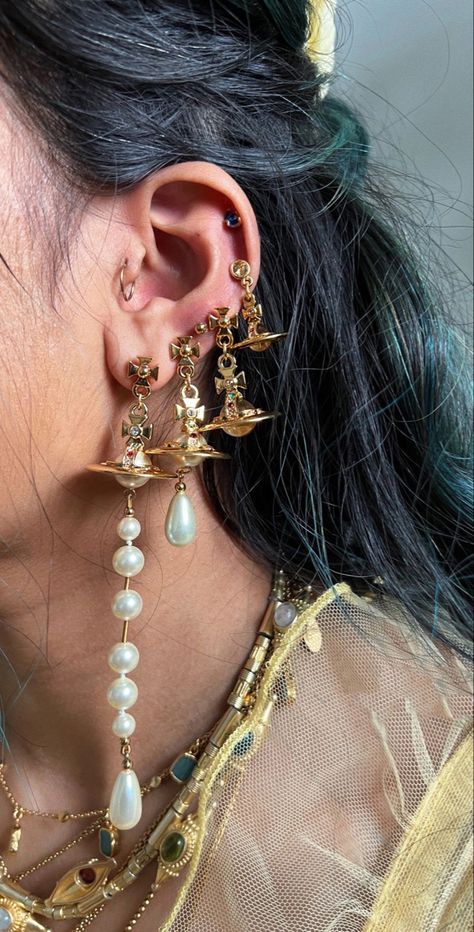 Goddess Ear Piercings, Heavily Pierced Ears, Vivienne Westwood Jewlrey, Gold Maximalist Jewelry, Vivienne Westwood Earrings In Ear, Curated Ear Piercing Maximalist, Maximalist Ear Stack, Maximalist Gold Jewelry Aesthetic, Vivienne Westwood Earrings