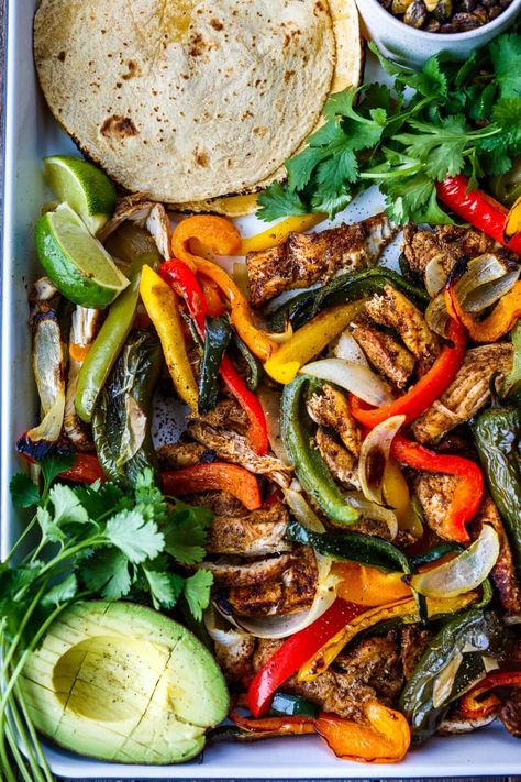 Sheet Pan Chicken Fajitas are a quick easy one-pan dinner! Deliciously marinated chicken and veggies are roasted until tender & succulent. Vegan Fajitas, Sheet Pan Chicken Fajitas, At Home Recipes, Feasting At Home, Baked Chicken Fajitas, Soy Curls, All Ideas, Pan Chicken Fajitas, Sheet Pan Chicken