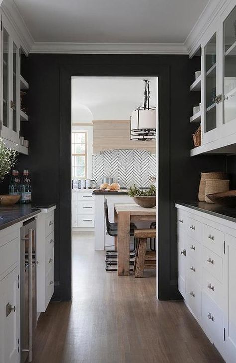 Black and white butler's pantry features walls painted black lined with white cabinets paired with black countertops. Kitchen Cabinets Black And White, Black Walls Kitchen, Black And White Cabinets, Black Painted Walls, Backsplash With Dark Cabinets, Best Kitchen Cabinets, Black Countertops, Kitchen Black, Dark Kitchen