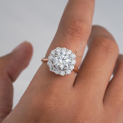 This exquisite ring from Auric Charms features a brilliant Round Cut Lab Grown Solitaire Brilliant Round diamond set in a halo of smaller diamonds. The ring is crafted from Real solid gold ( 10K, 14K, 18K ), 925 Silver, and Platinum and is perfect for use as an engagement or wedding ring. The ring is handmade and features an excellent cut grade, with  EF color grade and VVS-VS clarity grade. It is also nickel-free and stackable, making it a great choice for everyday wear. The ring is personalize Round Engagement Ring With Halo, Round Solitaire Halo, Engagement Ring With Halo, Ring With Halo, Engagement Rings Halo, Ring For Wedding, Round Cut Diamond Ring, Round Engagement Ring, Round Diamond Setting