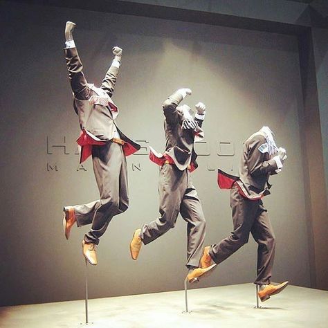 This window display uses attention getting devices such as repitition, motion, and color. The display doesn't contain any moving items but it was created to depict a stance of motion. The reptition of the three men mannequians with identical suits emphasizes the importance and or significance of the clothing. The technique of using the same color & suit but different motions was a good idea because the display is not too distracting & it allows you to actually focus on the suits. Light Sculpture Installation, Unique Mannequin, Mannequin For Sale, Fashion Window Display, Store Front Windows, Fashion Mannequin, The Suits, Retail Inspiration, Motion Capture