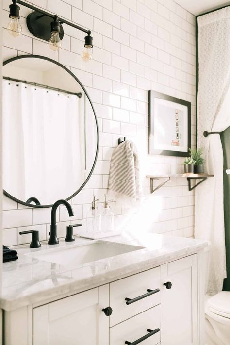 White subway ceramic tile bathroom with marble countertop, round mirror and black hardware. Black Fixtures, Ceramic Tile Bathrooms, Beautiful Bathroom Designs, Bad Inspiration, Budget Bathroom, Bathroom Redo, Round Mirror, Bath Remodel, Counter Top