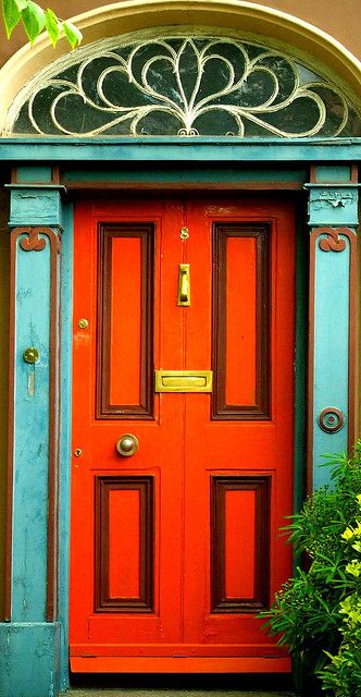 This is so cheerful! Love what a little bit of paint and detailing can do. For more ideas on highlighting your front entry visit: http://www.landscapingnetwork.com/front-yard-landscaping/home-entry.html Orange Door, When One Door Closes, Cool Doors, Main Door, Blue Door, Old Doors, Orange And Turquoise, Unique Doors, Door Color