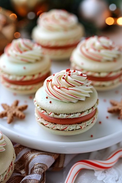 Festive macarons with red and white swirls and sprinkles on a plate, surrounded by holiday decorations. Macaron Place Setting, Macaron Italian Method, Fall Flavored French Macarons, Peppermint Macarons Recipe, Christmas French Macarons, Christmas Flavored Macarons, Cookie Butter Macarons, Macaron Template Free Printable, Fall Flavored Macarons