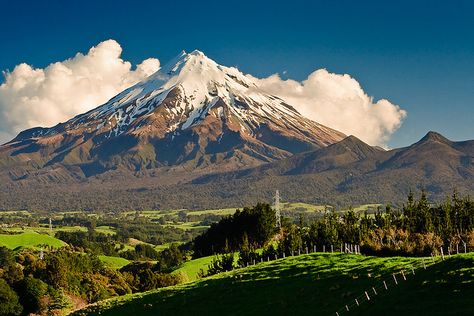 The conical form of Mount Taranaki on a rare afternoon when it is not entirely shrouded in cloud. Taranaki New Zealand, Mount Taranaki, Dormant Volcano, New Zealand North, Round The World, Beautiful Places In The World, Beautiful Places To Travel, Magical Places, Beautiful Places To Visit