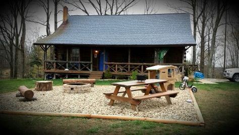 Large river rock patio with fire pit, picnic table and play area. Fire Pit And Picnic Table Area, Front Yard Picnic Table, Picnic Table Landscaping, Outdoor Table On Gravel, Picnic Table Area Backyard, Backyard Picnic Area, Rock Patio With Fire Pit, Gravel Patio With Fire Pit, Picnic Table Area