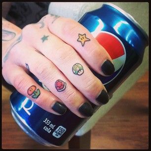 Super Mario Knuckle Tattoos | 30 Rad Tattoos Inspired By Nintendo  I wouldn't get them on my knuckles,but I would get a 1up shroom or the Star because their are the best Mario Tattoos, Super Mario Tattoo, Nintendo Tattoo, Video Game Tattoos, Mario Tattoo, Nerdy Tattoos, Gamer Tattoos, Nerd Tattoo, Knuckle Tattoos