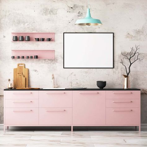 Attractive kitchen with light pink cabinetry topped with a black granite counter. It has floating shelves next to a whiteboard lighted by a mint green pendant. Pink Kitchen Cabinets, Pink Kitchen Ideas, Kitchen Interior Modern, Black Countertop, Pink Cabinets, Black Backsplash, White Marble Floor, Design Your Kitchen, All White Kitchen