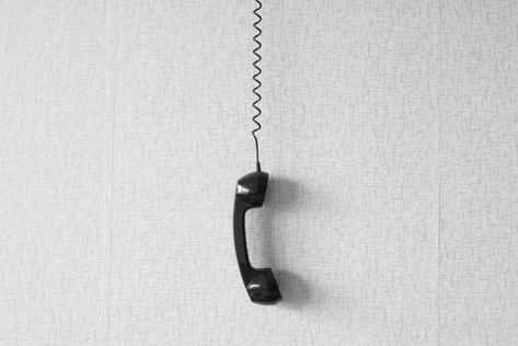 black old handset with a wire hang against wallpaper texture. black plastic telephone hanging by the cord.Retro Phone Cord - Vintage Telephone Handset Receiver hanging by the Cord down Numbers To Call, Wallpaper Texture, Wall Phone, Phone Cords, Vintage Phone, Doodle Icon, Retro Phone, Vintage Phones, Cell Phone Number