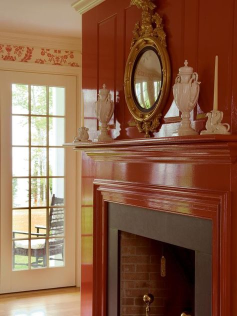 High-gloss red paint finishes off this paneled fireplace, a perfect complement to the floral wallpaper in the room. The shiny finish gives a more luxe, eye-catching look. French Country Fireplace, Fireplace Drawing, Sleek Fireplace, Country Fireplace, Wooden Beams Ceiling, Clean Fireplace, Paint Fireplace, Choosing Paint, Concrete Fireplace