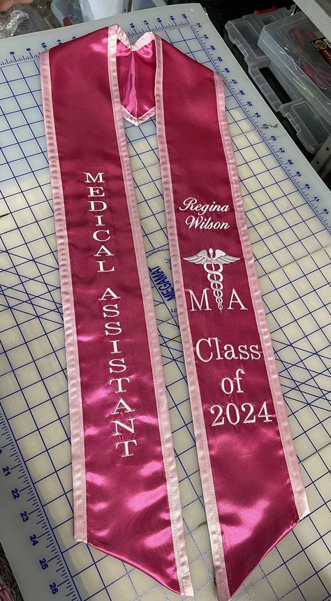 "Medical Assistant Graduation Stole Chiseled Stole personalized -Medical Assistant (Times Roman font) -Your Name (script font) -\"Medical Symbol MA\"      Use Pictures for reference, Will be just like pictures. - Class of 20XX (Script font) Write a note with  -Your Choice of Stole color - Your choice of edge color  -Your choice of thread color  Any additions will be an extra charge. -Message me for any particular color or any questions -Turn around time is 1 week production and 3-4 days for ship Medical Assistant Graduation Sash, Medical Assistant Aesthetic Pink, Med Assistant Aesthetic, Grad Stoles Ideas, Medical Assistant Job Duties, Ma Week Ideas, Stole For Graduation, Ma Graduation Pictures, College Stole Graduation Ideas