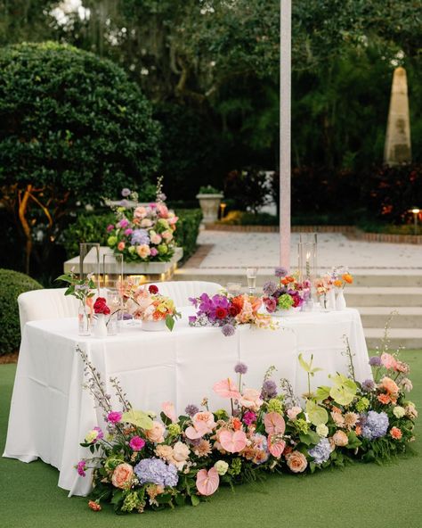 We are still swooning over these gorgeous florals by @bloomshakalaka and the stunning Sweetheart Table setup! Coordination & Design: @mdpevents Photographer: @dewittforlove Venue: @hardemanssecretgarden Florist: @bloom.shakalaka Videographer: @shannonkellyfilms Catering: @cbkcatering Cake: @tampabaycakecompany Rentals: @kateryaneventrentals Linens: @cdlinen DJ/Fusion Band: @irockyourparty Hair & Makeup: @hardtyoumore Transportation: @charterUP @dolphintransportation Newlyweds: @rtgive . . . ... Spring Sweetheart Table, Purple Sweetheart Table, Colorful Sweetheart Table, Wedding Sweetheart Table Flowers, Floral Sweetheart Table, Bridgerton Brunch, Sweetheart Table Flowers, September Wedding Flowers, Fruit Wedding