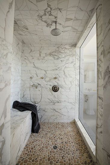 Stone everywhere in this marble shower with a pebble mosaic floor. Gorgeous and simple. Mosaic Pebble, Pebble Shower Floor, Stone Tile Bathroom, Calcutta Gold Marble, Marble Shower Tile, Shower Mosaic, Pebble Floor, Stone Shower, Gold Tile