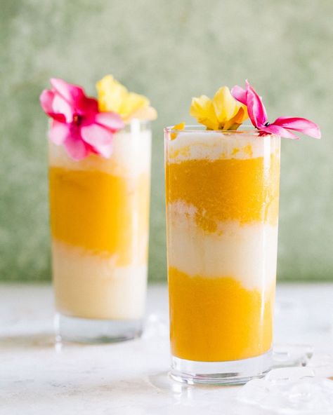 two mango and coconut cocktails with pink and yellow flowers Lava Flow Drink Recipe, Lava Flow Drink, Dessert Tamales, Coconut Cocktails, Heartbeet Kitchen, Protein Packaging, Mango Varieties, Mango Cocktail, Summer Drink Cocktails