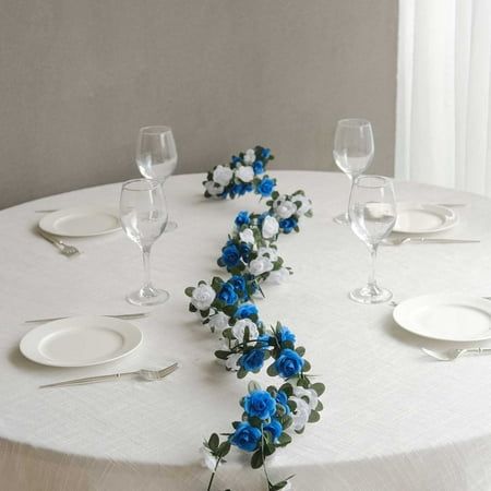 Stunning White Royal Blue Artificial Rose Flower Garland Introducing our stunning White Royal Blue Artificial Silk Rose Flower Garland, the perfect piece to enhance any space with its timeless beauty and charm. Made from top-quality artificial silk roses, this garland adds a touch of grace and nature-inspired allure to your home or event. With 45 flower heads, our Flower Garland offers flexibility in decorating stair railings, mantels, or doorways for a fun look. Alternatively, hang it over arbo Royal Blue Centerpieces, Hanging Flower Garland, Vines Hanging, Wedding Party Centerpieces, Az Wedding, Flower Vines, Blue Centerpieces, Flower Stamen, Party Tables