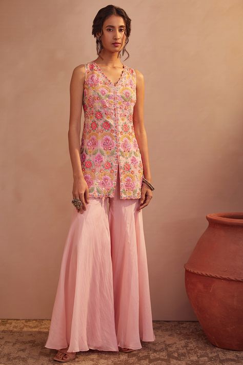 Featuring a peach short kurta in soft organza base with floral sequins, mirror, and thread hand embroidery. It is paired with matching sharara pants.  FIT: Fitted at bust and waist. COMPOSITION: Soft organza. CARE: Dry clean only. Suits For Women Indian, Kurta With Sharara, Kurta And Sharara, Sharara Designs, Sharara Pants, Function Dresses, Indian Designs, Trendy Outfits Indian, Short Kurta