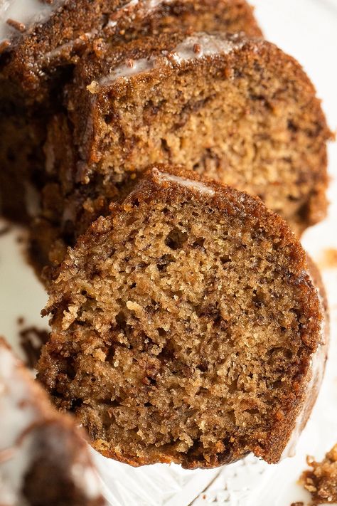 Tender and flavorful banana bread bundt cake made with overripe bananas, chocolate chips, or chocolate streusel and covered with a simple powdered sugar glaze. #whereismyspoon #bananabundtcake #bananabreadbundtcake #bananabreadrecipes #bananacake #bananarecipes #bakingcake #easybakes Banana Bread Bundt Pan, Banana Cake Bundt, Bundt Banana Bread Recipe, Banana Bread Recipe Bundt Pan, Bundt Pan Banana Bread, Bundt Cake Banana Bread, Banana Bread In Bundt Pan, Banana Bundt Bread, Banana Bundt Cake Recipes Easy