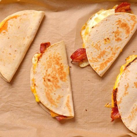 "This copycat Wake Up Wrap recipe is a classic breakfast from Dunkin Donuts. It's made with just 5 ingredients and is easy to make at home. It has crispy bacon, American cheese, and egg all wrapped up in a toasted tortilla. It's easy to eat on the go or to be enjoyed with a hot cup of coffee. Eat this Dunkin wake up wrap on it's own or with a side of fresh fruit! It's a perfect breakfast to start your day." Wake Up Wrap, Quick Breakfast Ideas, On The Go Breakfast, Sweet Potato Waffles, Wrap Recipe, Winter Cooking, Protein Packed Snacks, Breakfast Wraps, Cheese Wrap