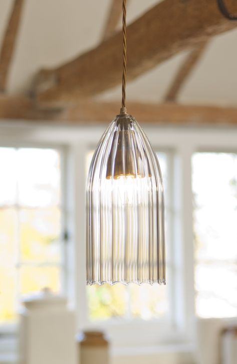 Whether hung on its own in the centre of a room or grouped together above a kitchen island or dining room table, the Thornton is a lovely statement light that will draw your eye to is fine proportions. Many of our customers use it as bedside lighting, fitting them above a bedside table as an alternative to more traditional table lamps. The hand blown, fluted glass shade is ‘frilled’ along the bottom rim, giving it a popular retro feel. Pendant Glass Lighting, Traditional Table Lamps, Fluted Glass, Statement Lighting, Lighting Trends, Flute Glass, Bedside Lighting, Lighting Inspiration, Glass Pendant Light