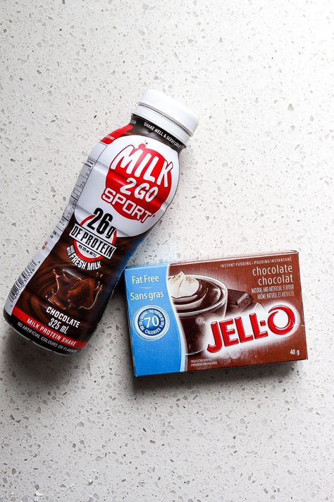 Top down view of chocolate protein shake and box of chocolate jell-o mix on white countertop. Quick Healthy Dessert, Chocolate Protein Pudding, Two Ingredient Desserts, Chocolate Protein Shake, Top Down View, 2 Ingredient Recipes, Chocolate Protein Shakes, White Countertop, Chocolate Pudding Recipes