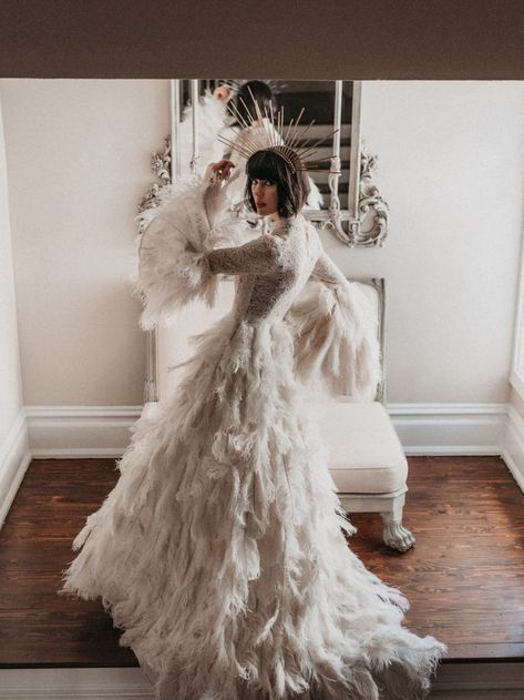 This ivory ostrich feather gown was inspired by 1970s bell sleeve dresses. Hundreds of ostrich feathers are individually applied to a natural cotton base. Lace on bodice has tiny sequins. Feathered Wedding Dress, Luxury Miami, Wedding Dress With Feathers, Feather Gown, Dubai Wedding, Destination Wedding Photos, Video Team, Blush Bridal, Luxury Destination Wedding