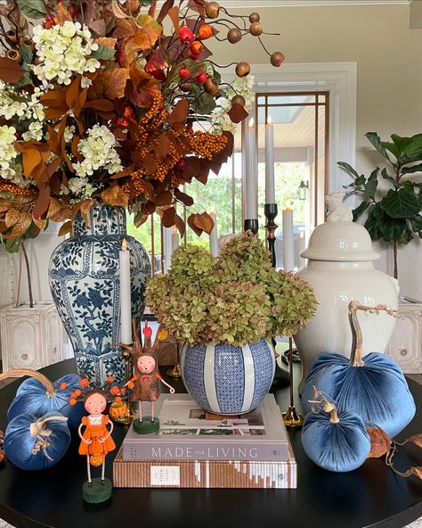 🍂💙🍂 The entry table is all set for Fall! I always love changing up my entry table for each holiday. The new faux florals are so pretty, warm and inviting. I have layers and layers of battery operated candles that come on automatically and cast the most beautiful warm glow. I have our Ocean Velvet Pumpkins placed on each side with a few fall leaves. The hydrangeas in our striped round jar are fresh. I clipped these from my limelight’s that are turning the best fall colors already. Last but cer... Planting Mums, Entry Table Decor, Fall Tablescapes, Battery Operated Candles, Velvet Pumpkins, Blue And White Porcelain, Entry Table, Faux Florals, Fall Leaves