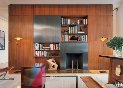 hidden tvs - TV concealed behind a sliding bronze pane set into a wood partition cabinet in a New York apartment study by Shelton Mindel & Assocs. - AD via Atticmag Hidden Tv, Manhattan Apartment, Terrazzo Flooring, Wall Mounted Tv, Fireplace Wall, Interior Wall, Living Room Tv, Home Tv, Home Entertainment