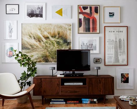 Ugh. A framed art cluster -- but I like it and need ideas for a massive wall behind my TV. I like that the large piece isn't centered above the TV. Tv Gallery Wall, Ruang Tv, Reka Bentuk Dalaman, Hiasan Dalaman Rumah, Deco Zen, Veronica Mars, Casa Vintage, Mobile Tv, Family Rooms