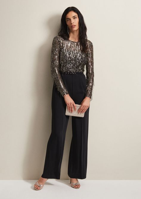 All I Want For Christmas Is This Jumpsuit. Our Mariah Jumpsuit Was Made For Dancing. It Features A Black Semi-Sheer Long Sleeved Top Covered In Sequin Fringe Detailing That Will Make Beautiful Movement All Night Long. It Falls To A Black Wide Leg Trouser With Pressed Seams Down The Front And A Matching Belt. Be Prepared To Answer Where It'S From!This Style Is Responsibly Sourced. Crafted From Certified Recycled Polyester And Recycled Sequins, This Style Has Been Designed To Have As Little Materi Party Pants Outfit Night Out, Black Semi Formal Outfits For Women, Wedding Guest Outfit Trousers, Pants Party Outfit, Semi Formal Outfits For Women Parties, Sequin Top Outfit, Formal Outfits For Women Parties, Semi Formal Outfits For Women, Wide Leg Trousers Outfit