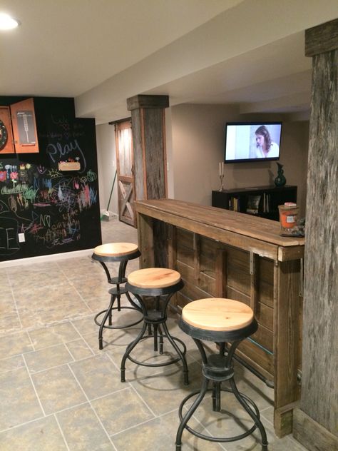 Bar rail barn wood poles basement Basement Pole Tables, Basement Support Pole Ideas Bar, Basement Ideas With Poles, Basement Support Pole Ideas, Bar Table Around Basement Pole, Basement Remodel With Poles, Hide Pipes, Basement Refinishing, Bar Rail