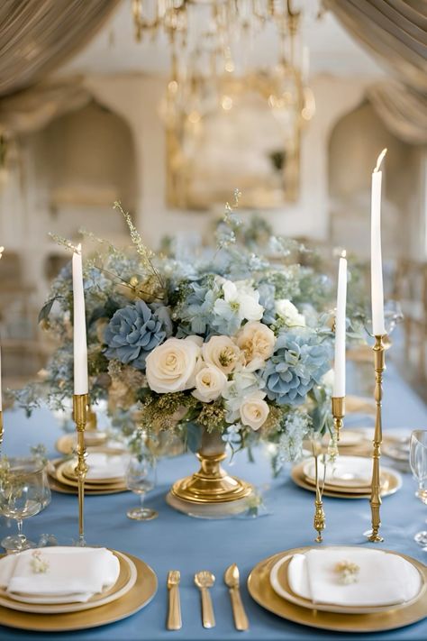 Dusty blue and gold wedding table decor     #dustybluewedding #dustyblueandgoldwedding #dustyblueweddingdecor #weddingflowers #weddingtablecenterpieces #weddingtablescapes #dustyblueandgoldweddinginspiration Blue Linen Wedding Table, Dusky Blue Wedding Decor, Blue Victorian Wedding Theme, Dusty Blue And Gold Color Palette, Steel Blue And Gold Wedding, Pastel Blue And Gold Wedding, Blue Cream And Gold Wedding, Baby Blue And Cream Wedding, Dusty Blue Wedding Theme Table Settings Centerpieces