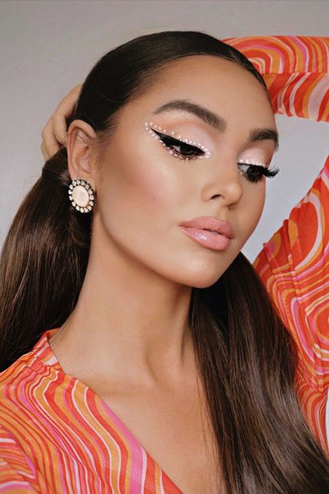 Jackie Wyers is dressed in a groovy orange top, big pearl earrings and bold, 1960s inspired makeup. The look is a recreation of Ariana Grande's Makeup line promotional photos! Ariana Grande 60s, Disco Makeup 1970s, 60s Makeup Tutorial, 60s Inspired Makeup, 1970s Makeup, Jackie Wyers, 1960s Makeup, Disco Makeup, Cute Photoshoot