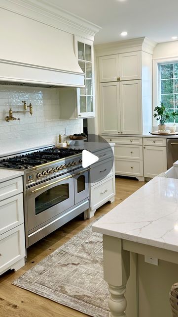 Leah White on Instagram: "The big debate… are all white kitchens out? Well if they are that’s ok because in 10 years from now I’m hoping this beauty will stand the test of time. I’ll forever love a timeless white kitchen. 
.#europeanvibes #newenglandhome 
.
.#timeless #kitchendesign #newbuildhome" Window Bar Counter, Backsplash Open Shelving, White Kitchen Dark Floors, Sink Window, Hidden Pantry, Window Bars, White Kitchens, Quartzite Countertops, Kitchen Renovations