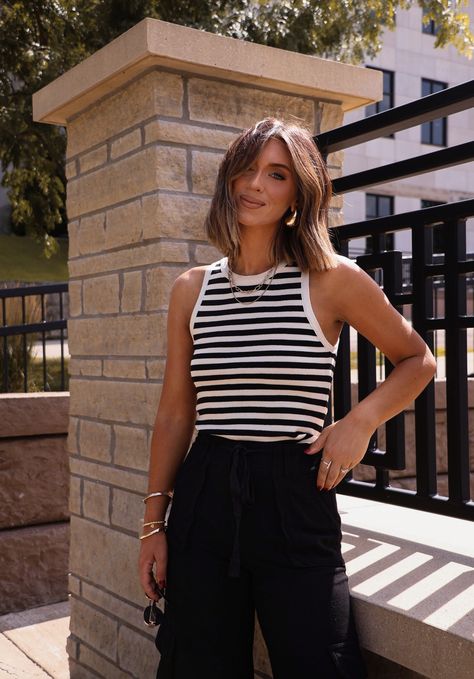 This striped crop tank is perfect for a business casual look. Its classic striped pattern adds a stylish touch while its cropped design allows for easy movement. A must-have addition to any wardrobe. Fabric 85% acrylic, 15% polyester Striped Top Outfit Summer, Striped Tank Outfit, Black And White Striped Top Outfit, Stripe Top Outfit, Sweater Tank Top Outfit, Striped Tank Top Outfit, Black Tank Top Outfit, Black Tank Tops Outfit, Sleeveless Top Outfit