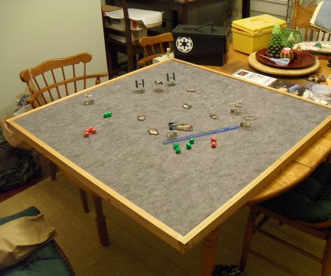 I built a 37 1/2' x 37 1/2' gaming table top, this is to be used for Miniature Games, Board Games, and anything that might require having to move it out of the way to use the table for meals. This a portable table top that games can be set up on and carefully moved out of the way and se...  Tip from the comments: Use  Automotive headliner which has foamy backing, is cheaper, and lasts longer(?). Diy Board Game Table, Diy Gaming Table, Top Board Games, Board Games Diy, Wargaming Table, Build A Table, Toppers Diy, Diy Table Top, Board Game Table