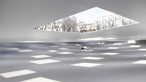 Rectangular openings allow sunlight and rain to enter this multipurpose covered plaza designed by Junya Ishigami for the Kanagawa Institute of Technology in Japan.