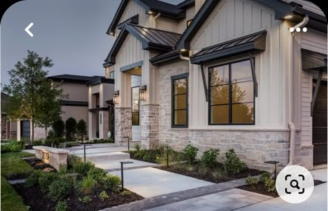 White House Dark Gray Roof, Stone Accent On House Exterior, 2 Story House Remodel Exterior, Gray Board And Batten Exterior With Stone, Exterior 2 Story House Ideas, White House Black Trim With Rock, Heavy Mortar Stone Exterior, Two Story Stucco House Exterior, Beige Modern Farmhouse Exterior