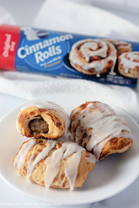 For a sweet and savory twist on a breakfast classic, make this fun Cinnamon Roll Wrapped Breakfast Sausage recipe. Cinnamon roll dough wrapped around a sausage and baked until golden brown then drizzled with frosting, a wonderful morning treat! #breakfast #cinnamonroll #sausage #pigsinablanket #easyrecipe Cinnamon Sausage Rolls, Sausage Cinnamon Roll Casserole, Breakfast With Link Sausage, Sausage Wrapped In Cinnamon Rolls, Cinnamon Roll Wrapped Sausage, Sausage Cinnamon Rolls, Cinnamon Roll Sausage Rolls, Breakfast Pigs In A Blanket Recipe, Breakfast Pigs In A Blanket